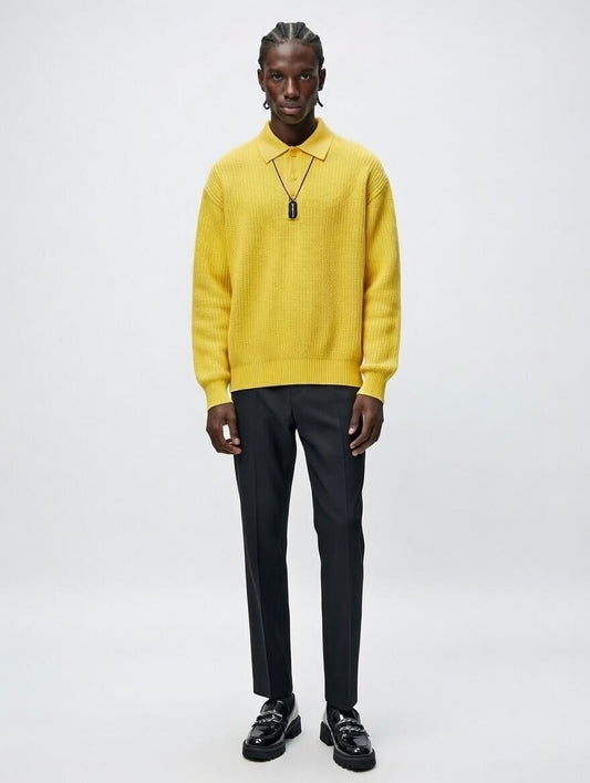 Person wearing a bright yellow sweater and black pants on a white background